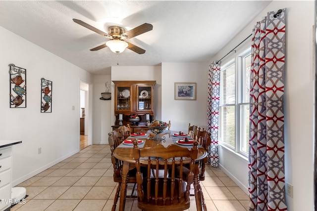 dining area with ceiling fan, a healthy amount of sunlight, and light tile patterned flooring