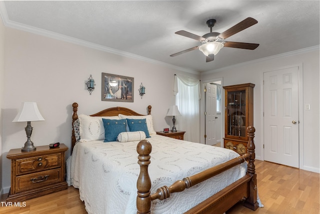 bedroom with ceiling fan, light wood-type flooring, and ornamental molding