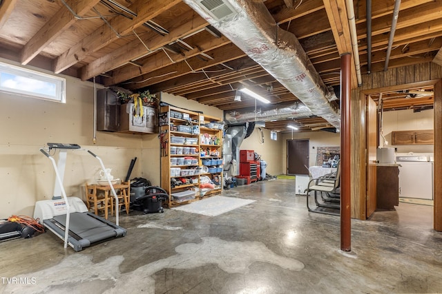 below grade area featuring visible vents and washer and clothes dryer