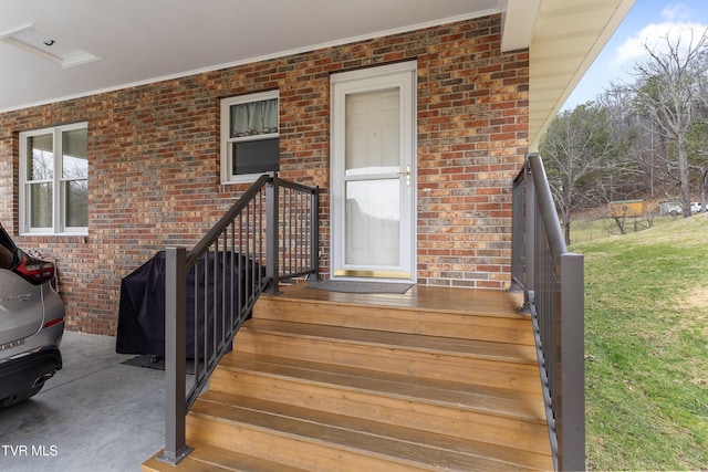 property entrance featuring brick siding