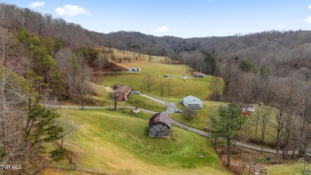 aerial view featuring a view of trees and a rural view