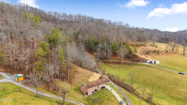 birds eye view of property with a rural view and a wooded view