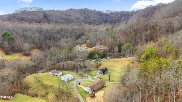 drone / aerial view with a wooded view