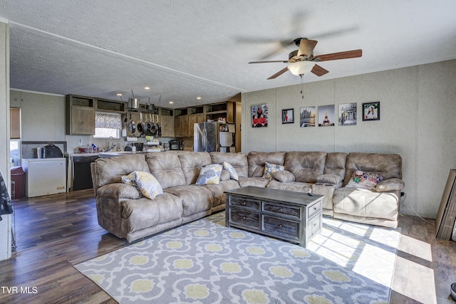 living room featuring a ceiling fan, a textured ceiling, and wood finished floors