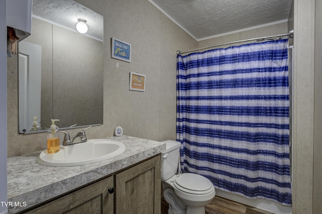 bathroom with ornamental molding, a textured ceiling, and vanity