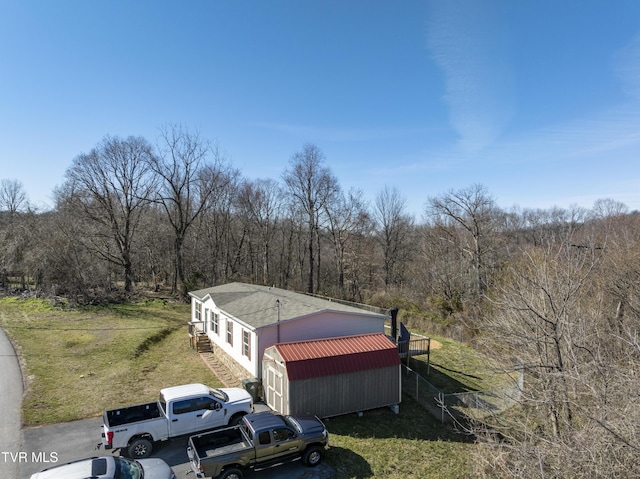 drone / aerial view featuring a wooded view