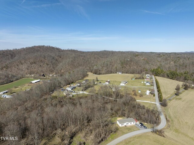 bird's eye view featuring a wooded view and a rural view