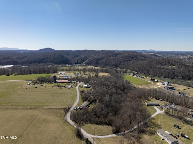 aerial view featuring a mountain view, a view of trees, and a rural view