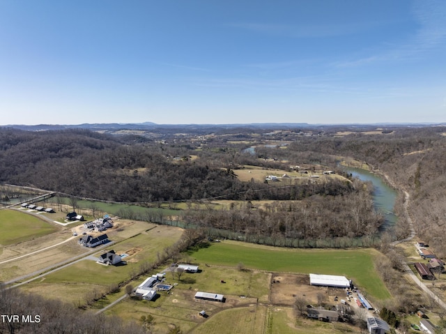 drone / aerial view with a water view, a forest view, and a rural view