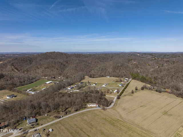 birds eye view of property featuring a view of trees