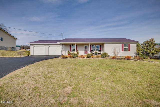 ranch-style house featuring driveway, a garage, metal roof, covered porch, and a front yard