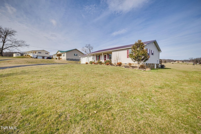 ranch-style house with a garage, central AC, and a front yard