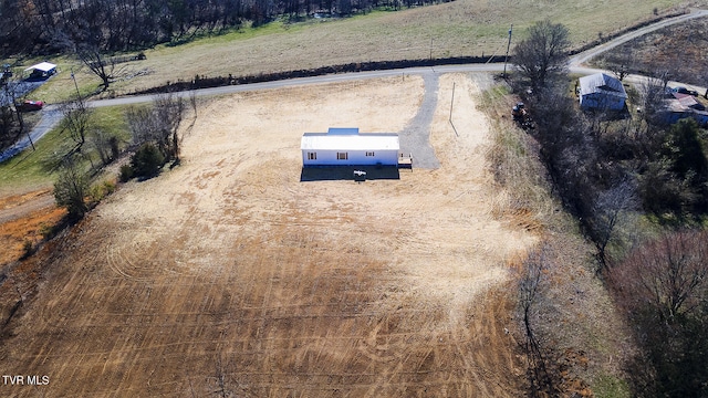 birds eye view of property with a rural view