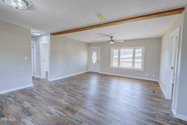 unfurnished living room with wood finished floors, visible vents, and baseboards