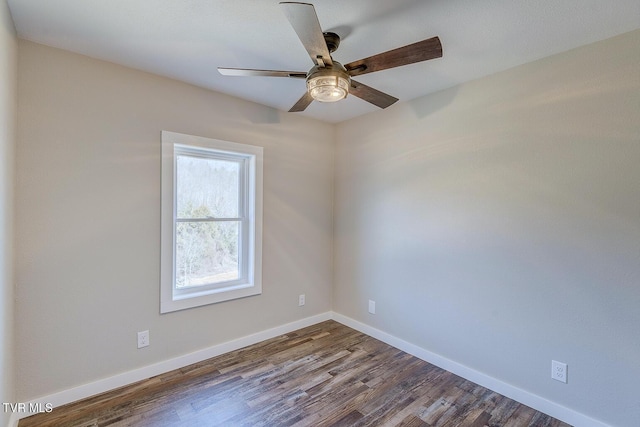 unfurnished room featuring ceiling fan, dark wood finished floors, and baseboards