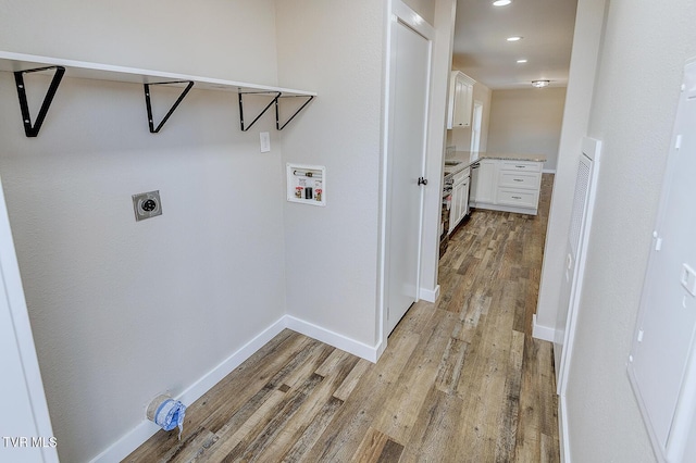 washroom featuring hookup for a washing machine, laundry area, light wood finished floors, and hookup for an electric dryer