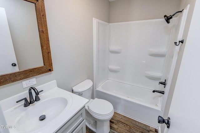 full bath featuring shower / bathtub combination, vanity, toilet, and wood finished floors