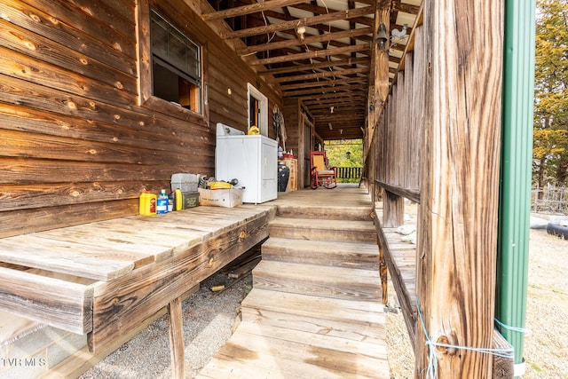 details featuring log exterior and washer and clothes dryer