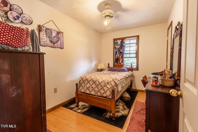 bedroom with wood finished floors and baseboards