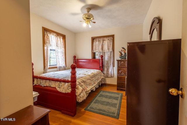 bedroom featuring a ceiling fan and wood finished floors