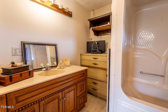 full bathroom featuring vanity, tile patterned floors, and a bathing tub