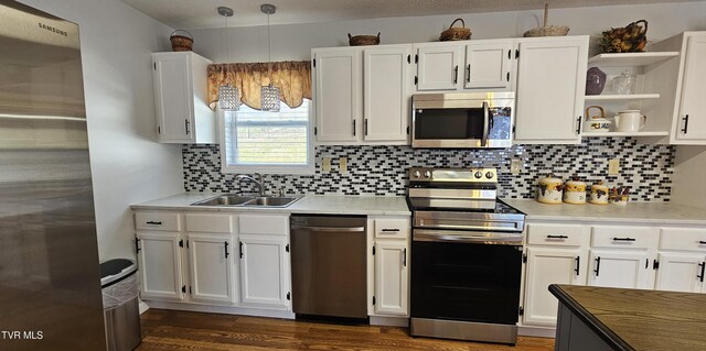 kitchen with white cabinetry, stainless steel appliances, and a sink