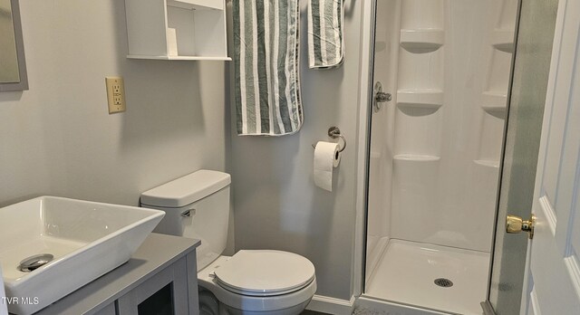 full bath with a shower stall, toilet, and vanity