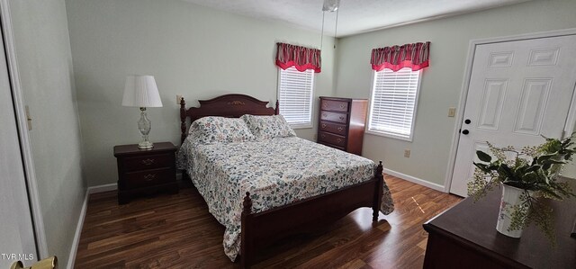 bedroom featuring dark wood-type flooring and baseboards