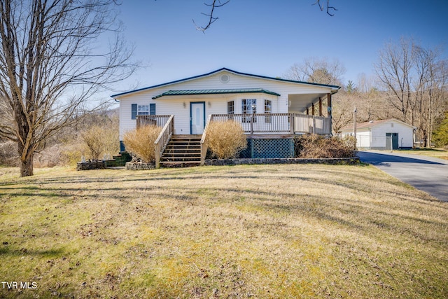 view of front of house featuring stairway and a front yard