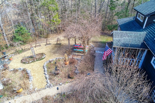 birds eye view of property with a wooded view