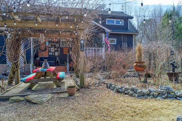 exterior space with roof with shingles