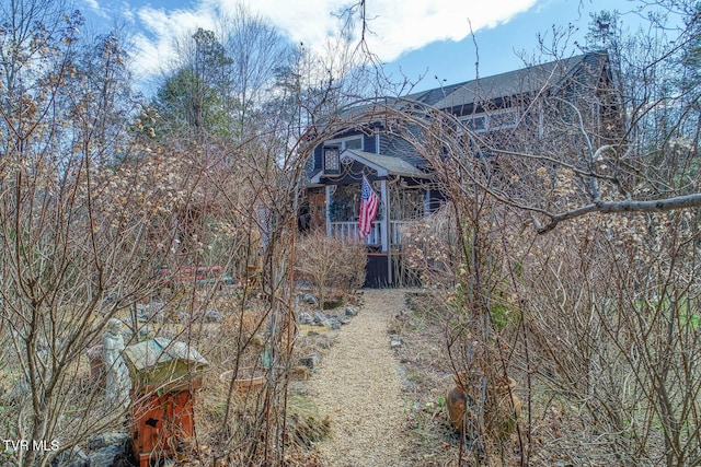 exterior space featuring a shingled roof