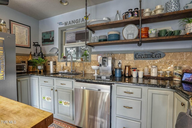 bar with appliances with stainless steel finishes, backsplash, and a sink