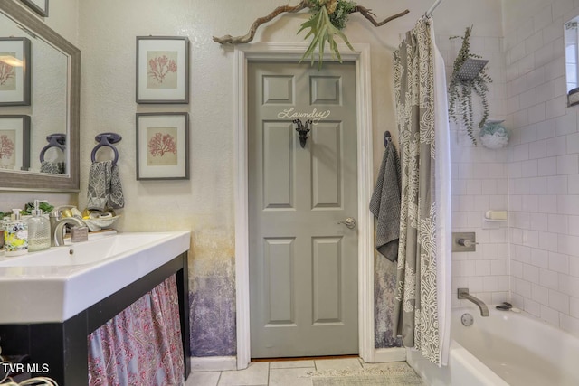 bathroom with tile patterned floors, shower / bathtub combination with curtain, and vanity