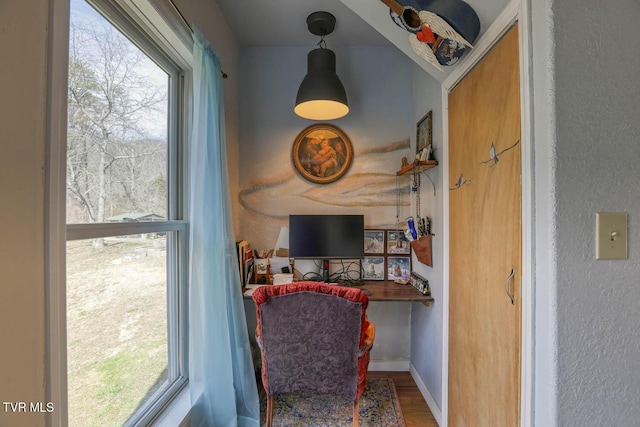 office space with baseboards and wood finished floors