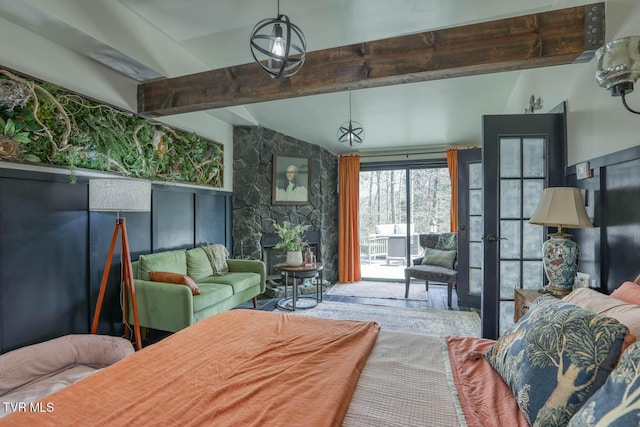 bedroom with vaulted ceiling with beams and access to outside