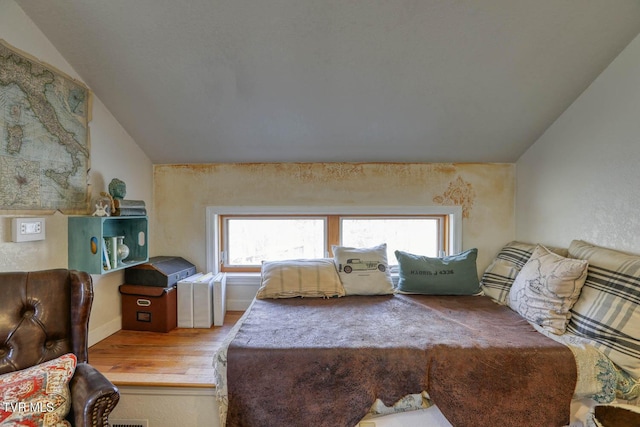 bedroom featuring vaulted ceiling and wood finished floors