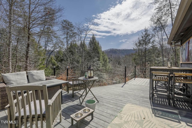 wooden terrace featuring a forest view