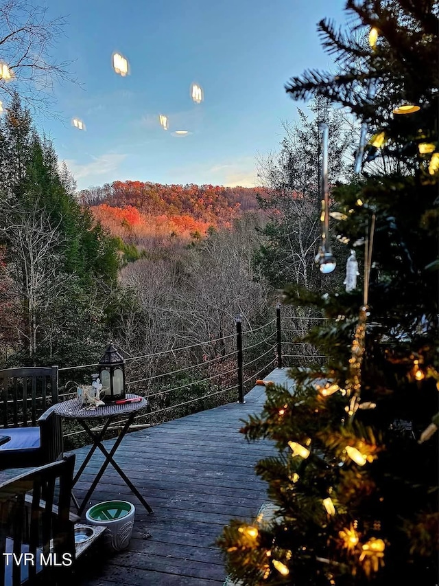 wooden terrace with a view of trees