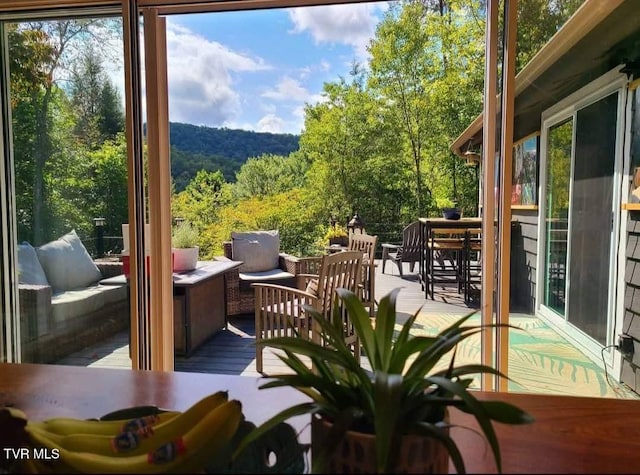 exterior space with wood finished floors and a view of trees