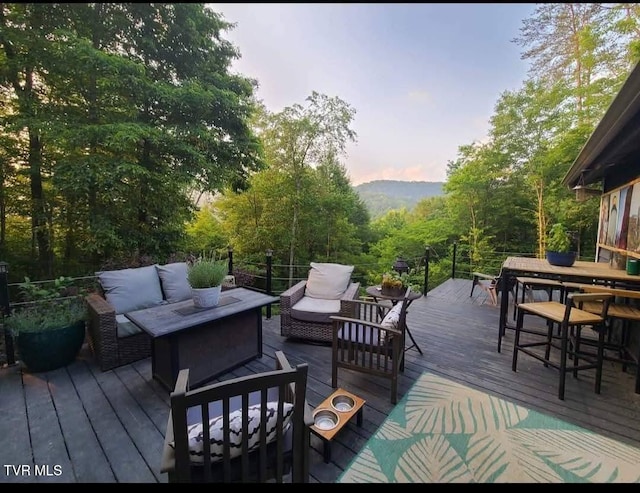 wooden terrace featuring an outdoor living space and outdoor dining space