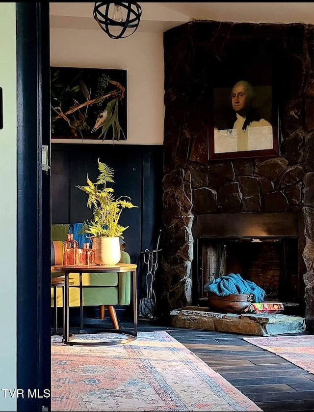 room details featuring a fireplace and wood finished floors