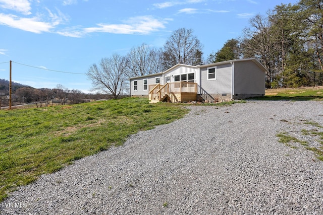 manufactured / mobile home with gravel driveway and crawl space