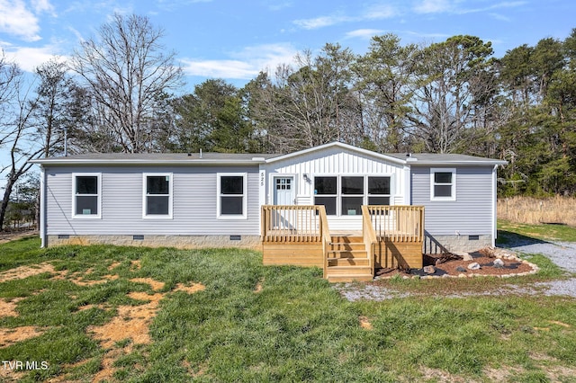 back of house featuring crawl space, a lawn, and a wooden deck