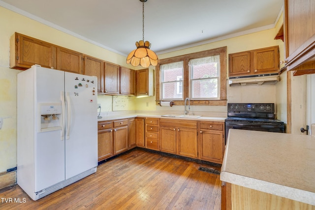 kitchen with under cabinet range hood, a sink, black electric range, white fridge with ice dispenser, and light countertops