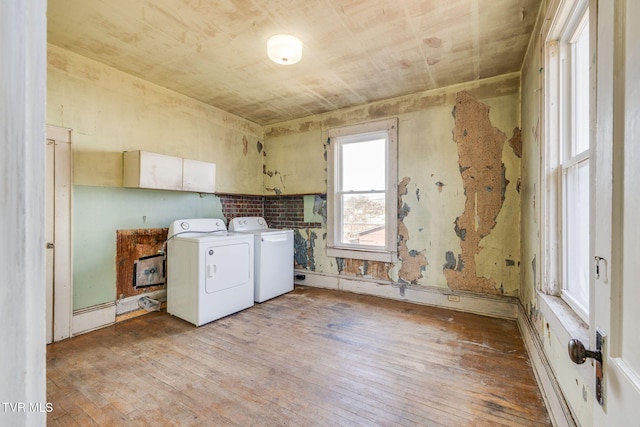 laundry room featuring cabinet space, independent washer and dryer, and light wood finished floors