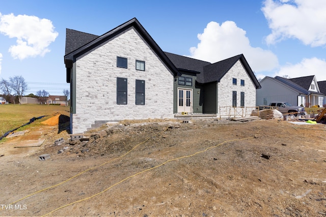 view of front of property featuring stone siding and french doors