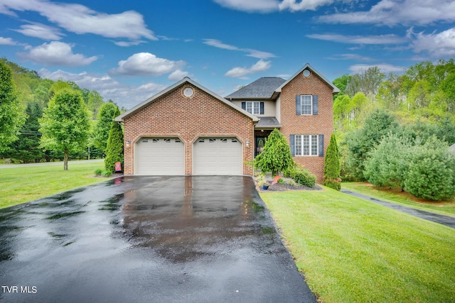 view of front of home featuring aphalt driveway, a garage, brick siding, and a front lawn