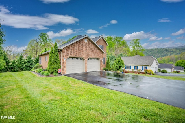 view of front of property with a garage, a front yard, aphalt driveway, and brick siding