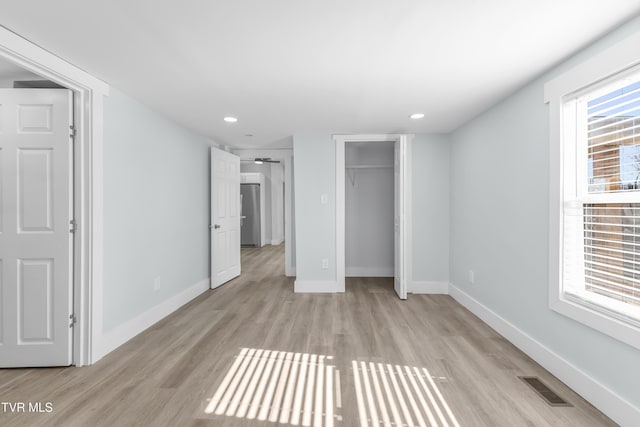 unfurnished bedroom featuring light wood-style floors, recessed lighting, visible vents, and baseboards